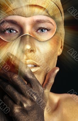 Portrait of young dancing girl with golden body art 