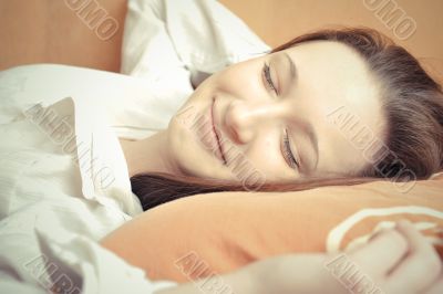 Closeup portrait of young pretty girl laying on her bed