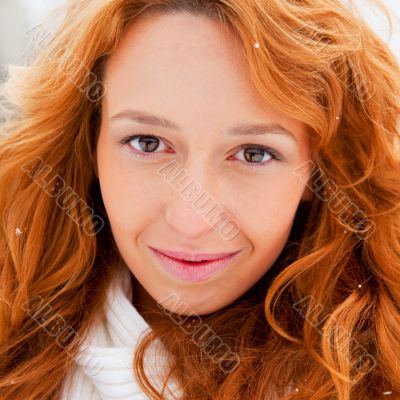 Portrait of young pretty woman in winter park 