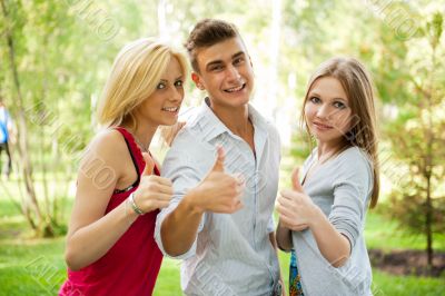 Portrait of three young teenagers laughing and having fun togeth