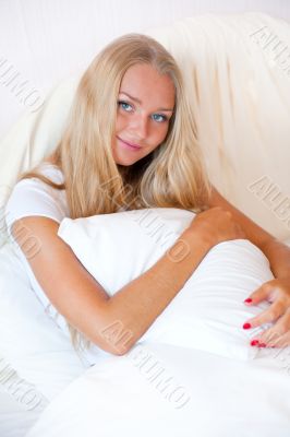 Portrait Of Young Woman Relaxing On Bed
