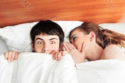 Young man and woman in bed. Couple.