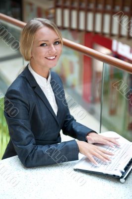Portrait of a pretty businesswoman sitting at cafe with a laptop