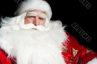 Santa Claus portrait smiling isolated over a black background