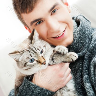 Relaxed man sitting on armchair holding and p