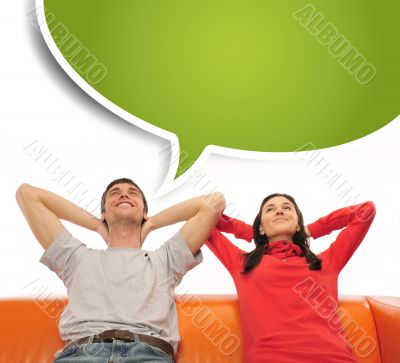 Young couple sitting on sofa and dreaming