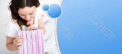 Portrait of young beautiful awake woman with gifts o