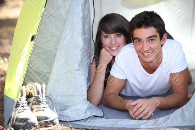 Teenage couple in a tent