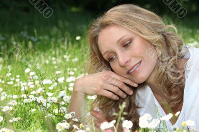 Woman lying in daisies
