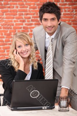 Smart couple with a laptop computer and cellphone