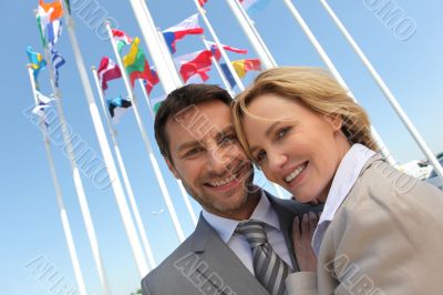 Businessman and woman with flags.