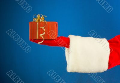 Santa`s hand holding a present