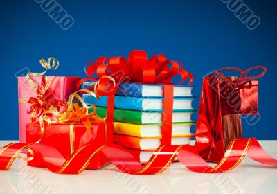 Christmas presents with stack of books