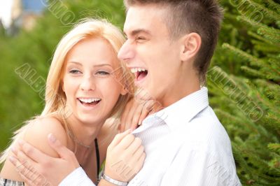 Young couple playing around in the nature - side view. Lots of c