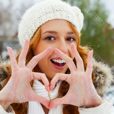 Portrait of beautiful young red hair woman outdoors in winter lo