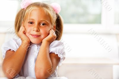 Image of smart child reading interesting book in classroom