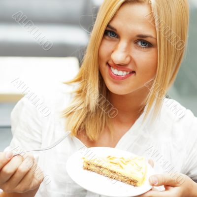 Portrait of young pretty smiling woman eating cake at shopping m