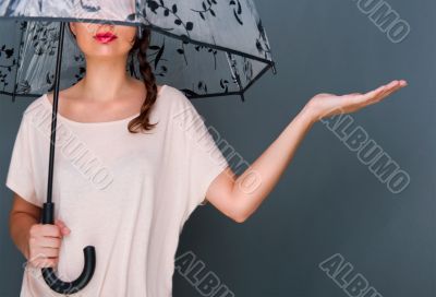Young fashionable woman holding umbrella stan