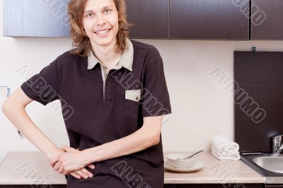 Happy young man after having a breakfast at home