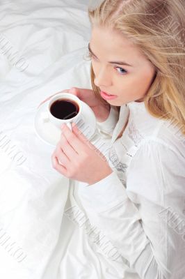 Portrait of young woman laying in bed
