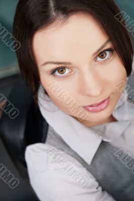 Portrait of young business woman sitting at her desk with a smil