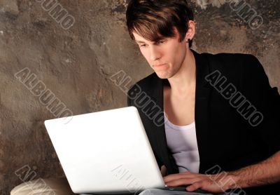 Happy businessman using laptop