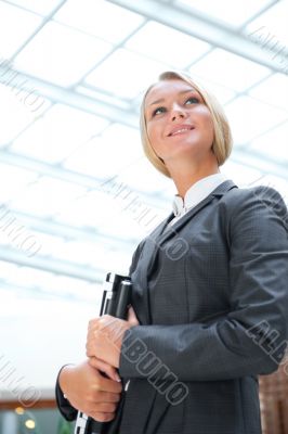 Portrait of a cute business woman with her laptop inside office 
