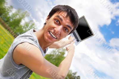 casual young man pointing at laptop screen