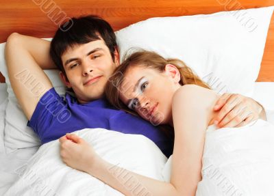 Young man and woman in bed. Couple.