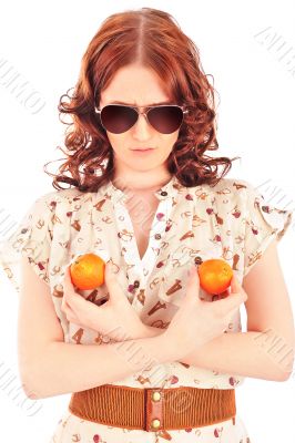 Shot of a beautiful young woman with mandarins near breast. Food