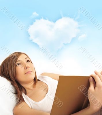Portrait of young pretty woman reading book 