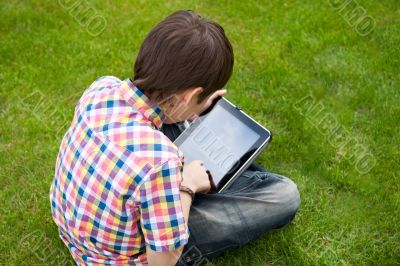 Young boy outdoors on the grass at backyard</