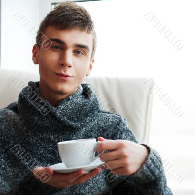 Portrait of a young man drinking coffe