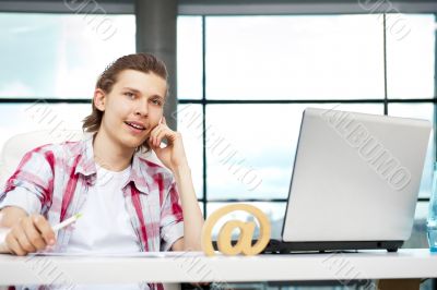 Portrait of handsome young man working with l
