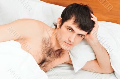 Man lying in bed smiling