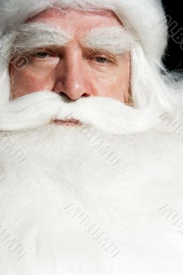 Santa Claus portrait smiling isolated over a black background