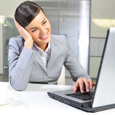 Young business woman on a laptop at her office. Working