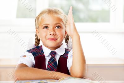 Portrait of a young girl in school at the desk.Horizontal Shot. 