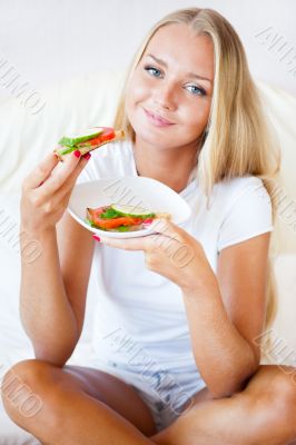 Woman having breakfast in bed. Healthy continental breakfast. Ca