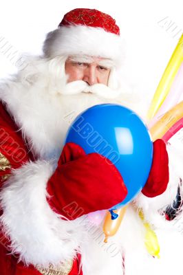 Traditional Santa Claus holding balloons for children. Isolated 