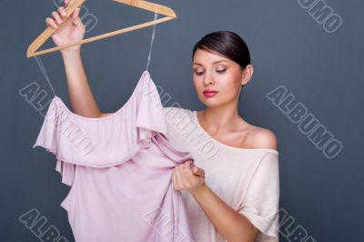 Portrait of pretty fashionable woman trying new clothes. Fashion