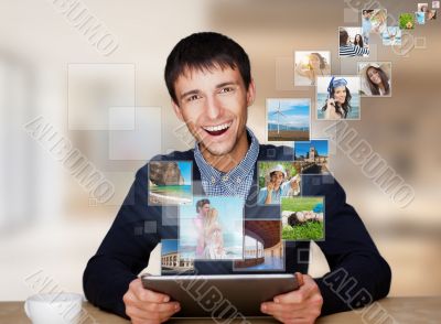 Portrait of young happy man sharing his photo and video files in