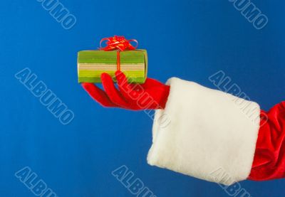 Santa`s hand holding a present