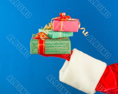 Santa`s hand holding presents