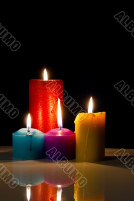 Four colourful burning candles
