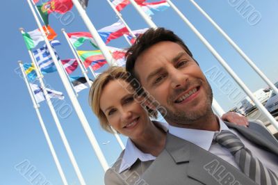 Businessman and woman with flags.