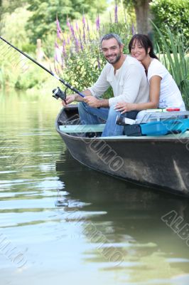 Couple fishing in a boat on a river