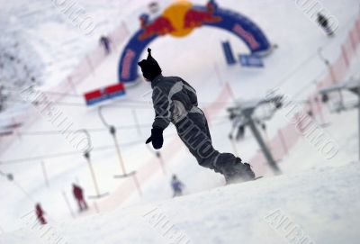 Snowboarder riding fresh powder snow