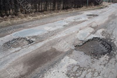 Damaged asphalt road after winter.