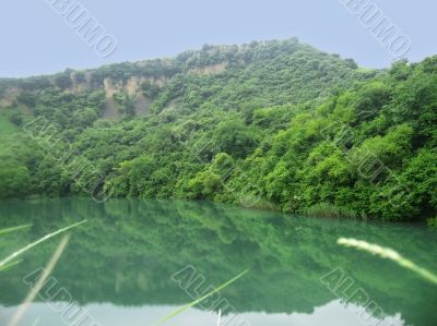 Small lake between the caucasus mountains summertime
